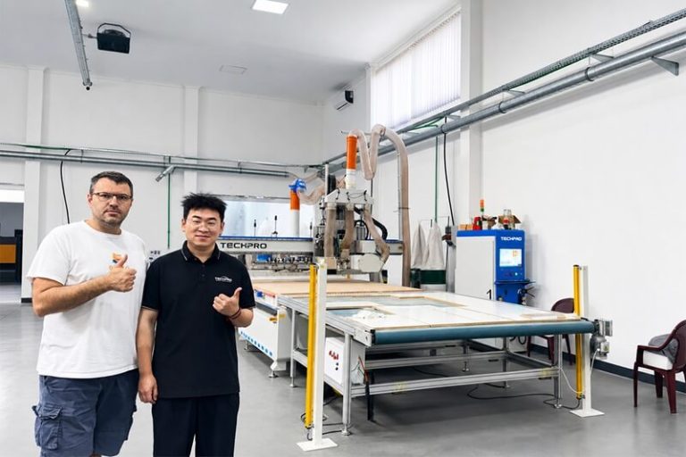 TechPro service engineer and customer beside a CNC router during on-site installation and after-sales service in Serbia.